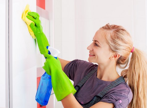 Trained carpet cleaner using PPE during a professional carpet clean